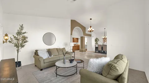 a hallway with a couch and chandelier