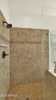 a view of a patio with table and chairs under an umbrella