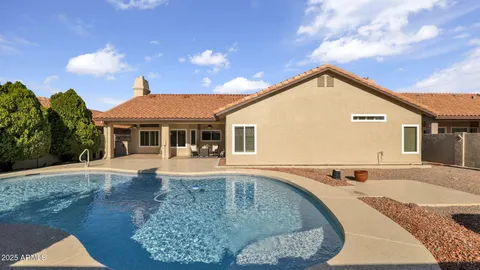 a view of a house with swimming pool and sitting area