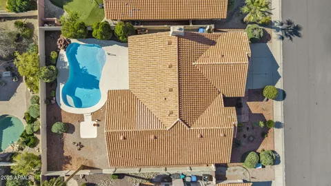 an aerial view of a house with a garden and lake view