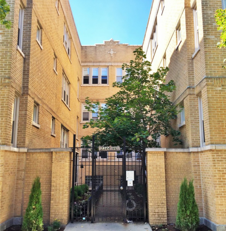 4439 West Fullerton Avenue, Unit 2 Chicago, IL 60639 - Photo 1 of 8 a city street lined with tall buildings