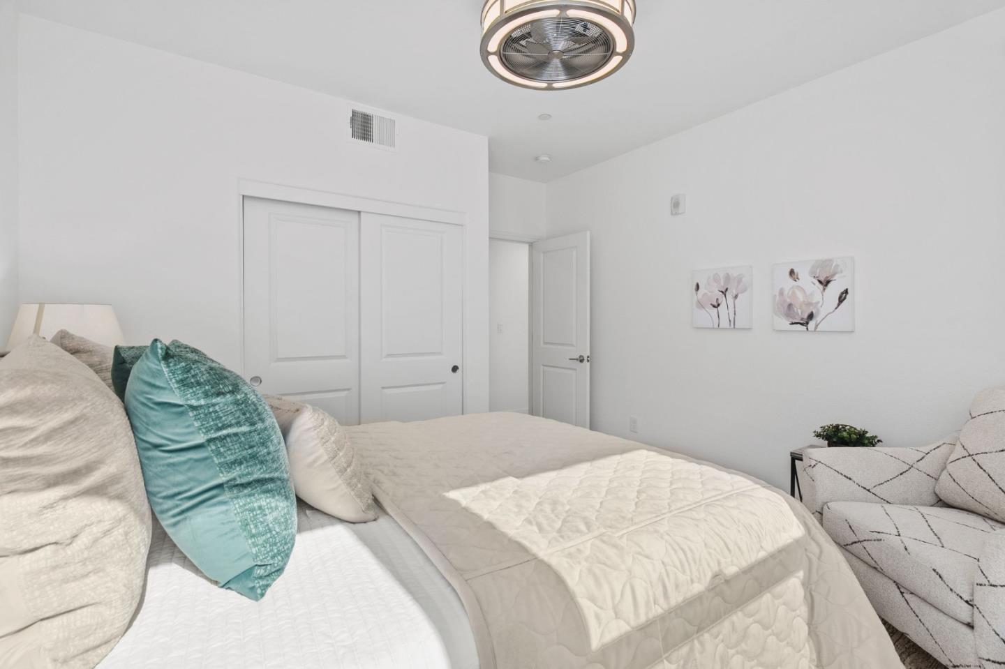1453 Cherry Circle Milpitas, CA 95035 - Photo 26 of 53 a bedroom with a bed and a chandelier