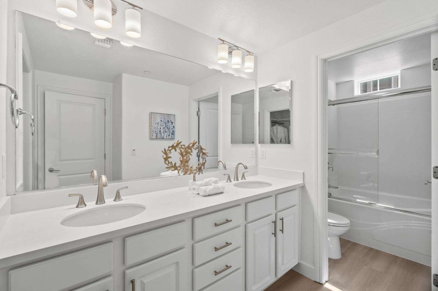 1453 Cherry Circle Milpitas, CA 95035 - Photo 31 of 53 a bathroom with a granite countertop sink a toilet a large mirror a bathtub and shower