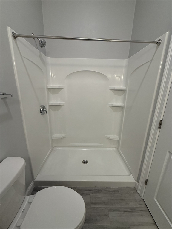 20 Locust Street, Unit 311 Danvers, MA 01923 - Photo 12 of 13 a bathroom with a shower and toilet