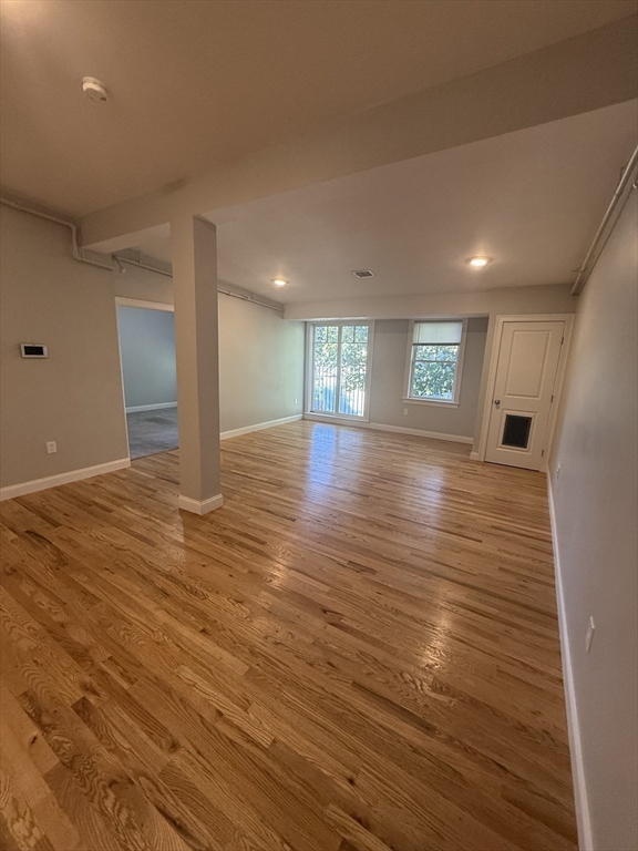 20 Locust Street, Unit 311 Danvers, MA 01923 - Photo 3 of 13 a view of an empty room with window and wooden floor