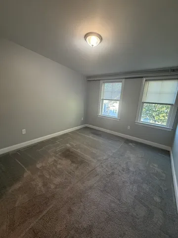an empty room with windows and entrance
