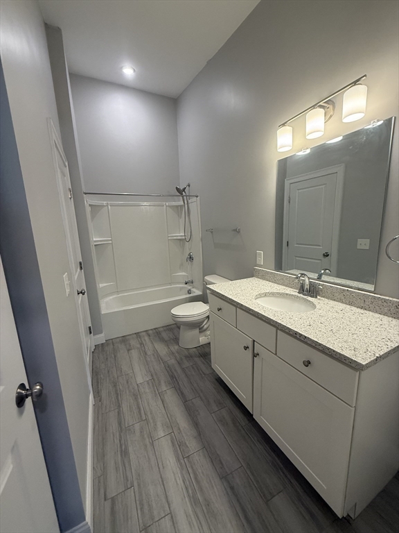 20 Locust Street, Unit 311 Danvers, MA 01923 - Photo 7 of 13 a bathroom with a granite countertop sink toilet and shower