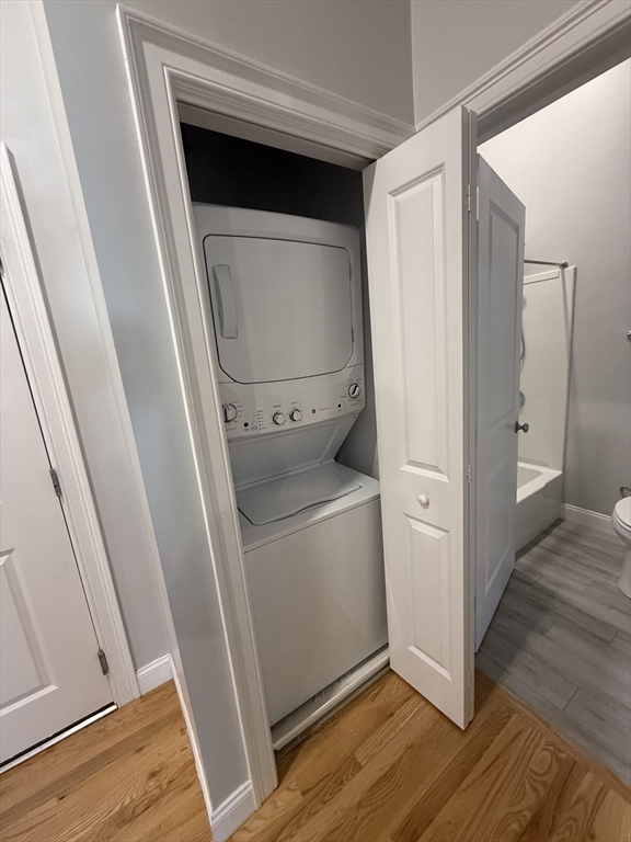 20 Locust Street, Unit 311 Danvers, MA 01923 - Photo 8 of 13 a view of washer and dryer with wooden floor