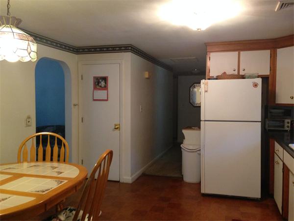 31 A George Brown Street Billerica, MA 01821 - Photo 4 of 8 a kitchen with a refrigerator a table and chairs