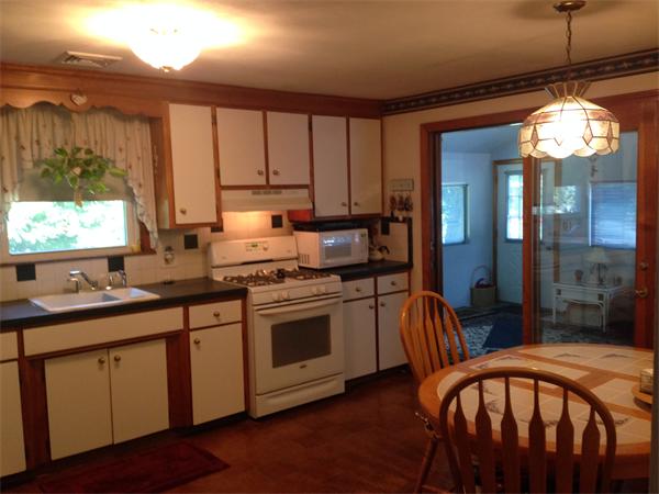 31 A George Brown Street Billerica, MA 01821 - Photo 5 of 8 a kitchen with granite countertop a stove a sink and a refrigerator