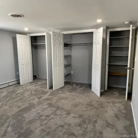 a view of an empty room with a closet