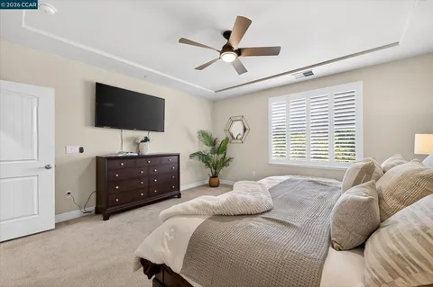 a bedroom with a large bed and a flat screen tv