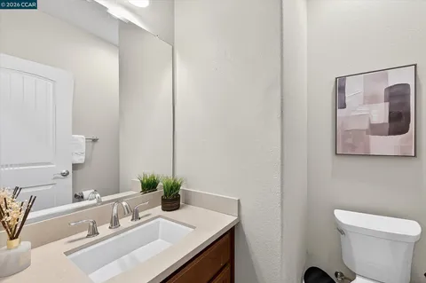 a bathroom with a sink a toilet and mirror