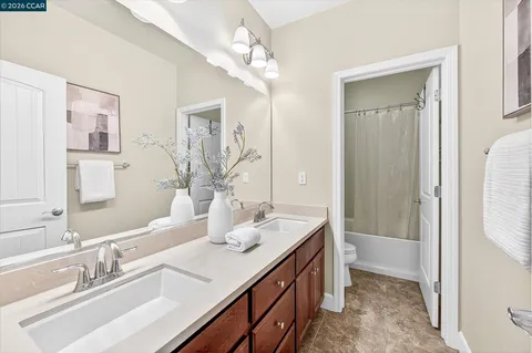 a bathroom with a sink double vanity and a mirror