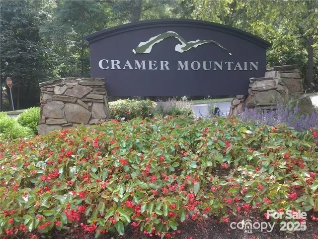 a sign that is sitting in front of flowers