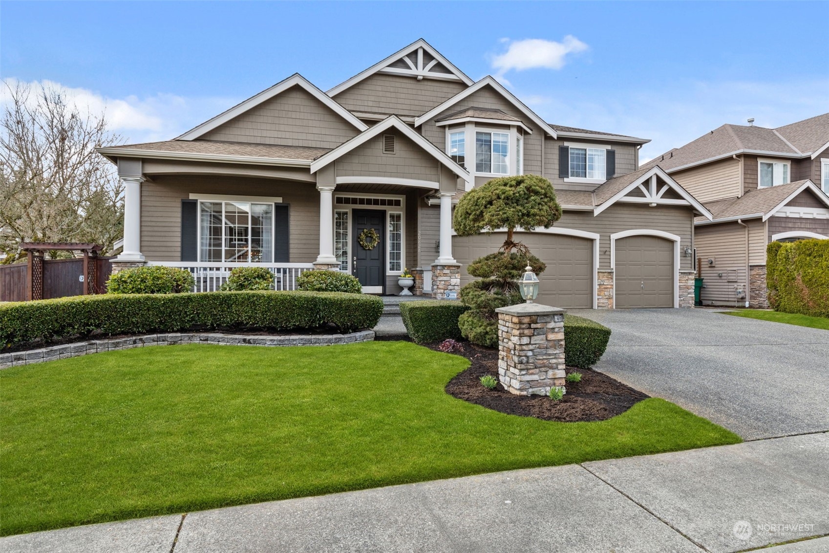 a front view of a house with a garden and plants
