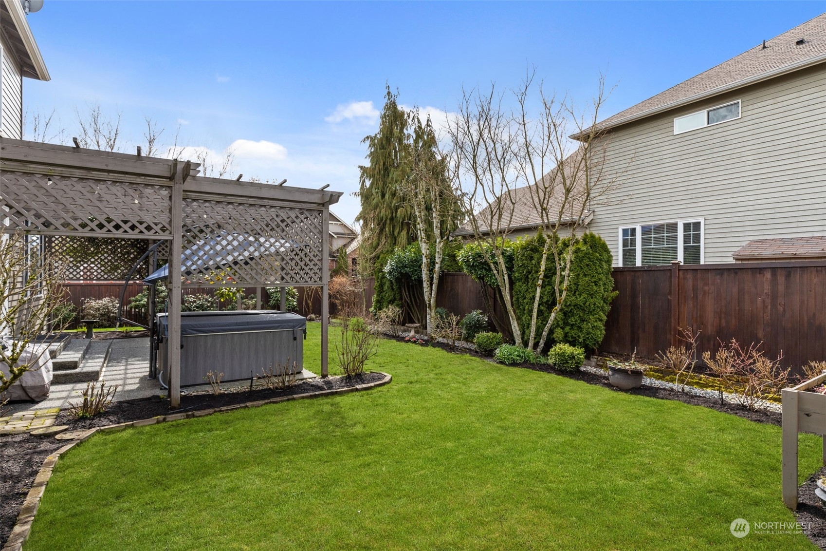 20828 37th Avenue Southeast Bothell, WA 98021 - Photo 33 of 38 a view of a backyard with potted plants and a large tree