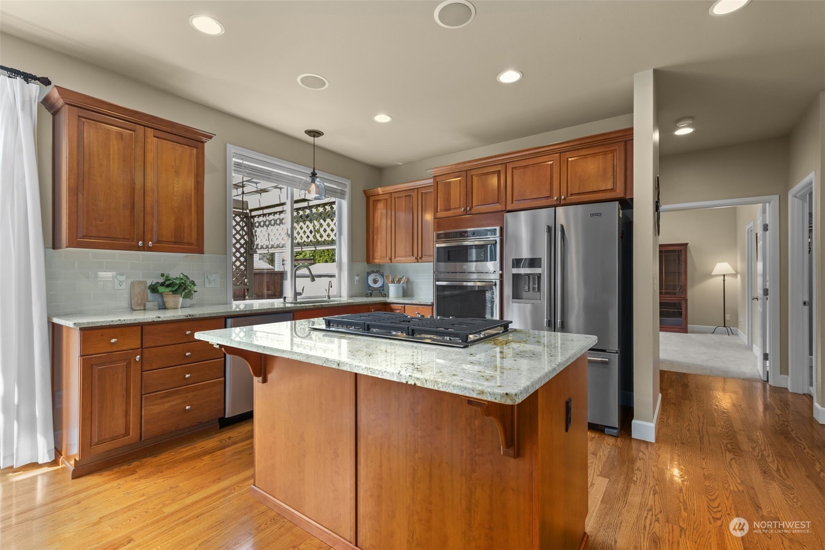 20828 37th Avenue Southeast Bothell, WA 98021 - Photo 7 of 38 a kitchen with stainless steel appliances granite countertop a sink refrigerator and cabinets