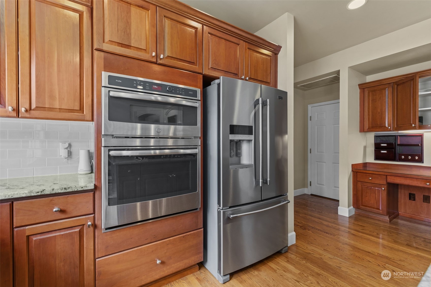 20828 37th Avenue Southeast Bothell, WA 98021 - Photo 9 of 38 a kitchen with granite countertop stainless steel appliances and wooden cabinets