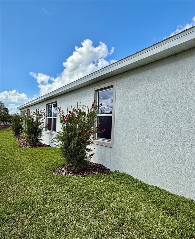 3222 Bitterroot Lane Bradenton, FL 34211 - Photo 5 of 34 a front view of a house with a yard
