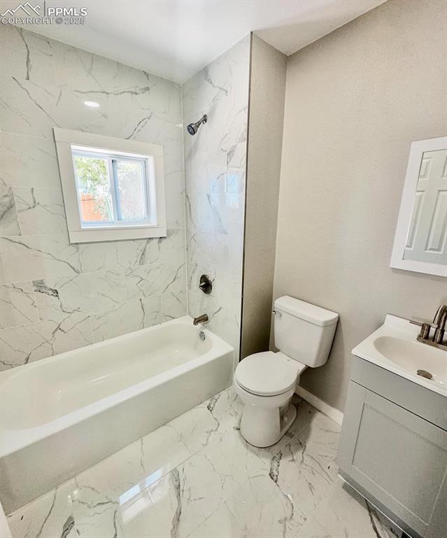 716-718 West Madison Street Colorado Springs, CO 80907 - Photo 6 of 8 a bathroom with a sink toilet and shower