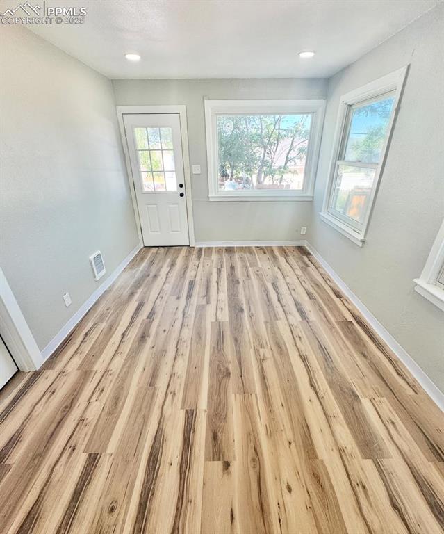 716-718 West Madison Street Colorado Springs, CO 80907 - Photo 7 of 8 an empty room with wooden floor and windows