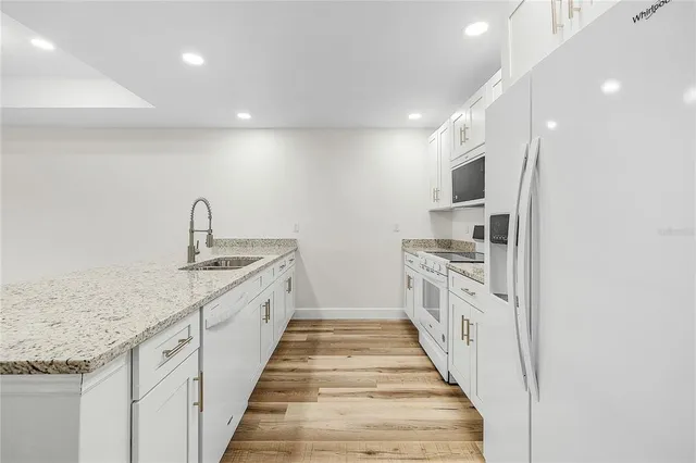 a hallway with sink and mirror