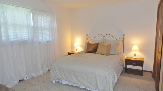 11 Prairie Drive Addison, IL 60101 - Photo 11 of 20 a bedroom with a bed and a night stand