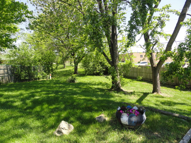 11 Prairie Drive Addison, IL 60101 - Photo 18 of 20 a backyard of a house with a yard and outdoor seating