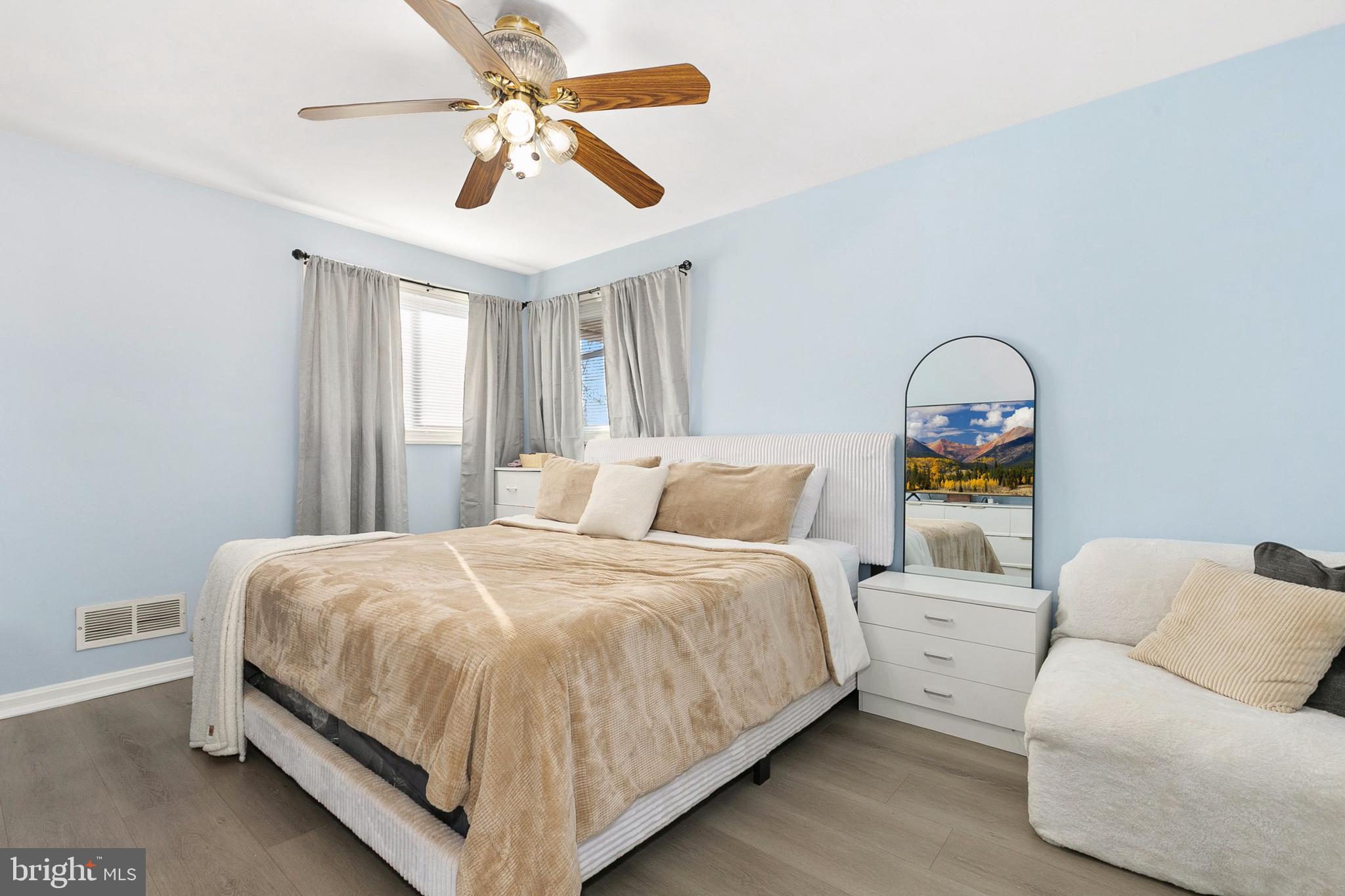 9632 Cottrell Terrace Silver Spring, MD 20903 - Photo 15 of 36 a bedroom with a bed couch and window