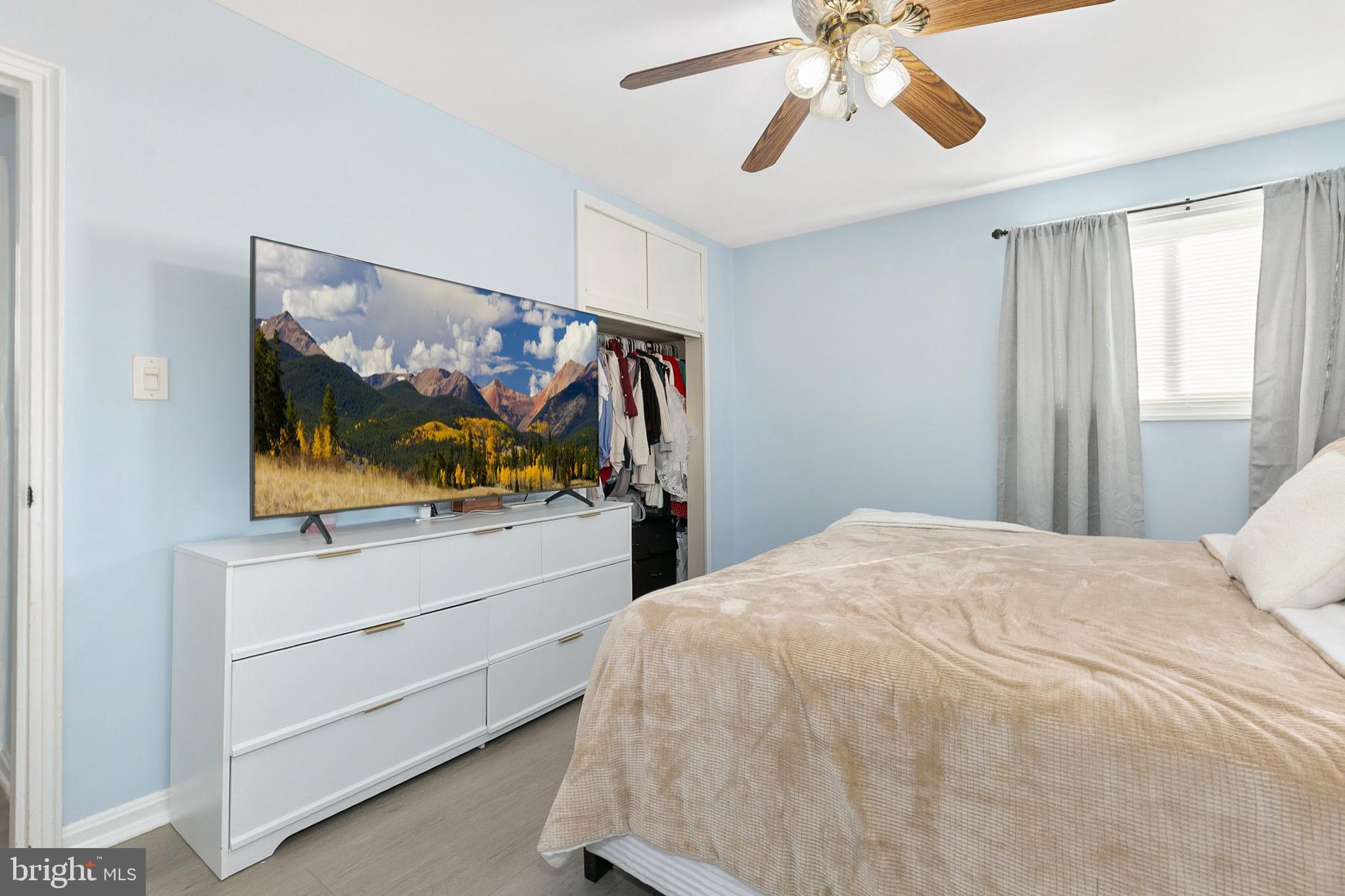 9632 Cottrell Terrace Silver Spring, MD 20903 - Photo 16 of 36 a bedroom with a bed and a flat screen tv