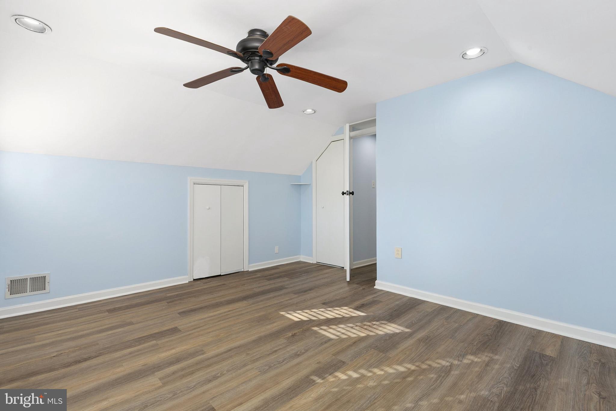 9632 Cottrell Terrace Silver Spring, MD 20903 - Photo 27 of 36 a view of a big room with wooden floor a ceiling fan and a ceiling fan