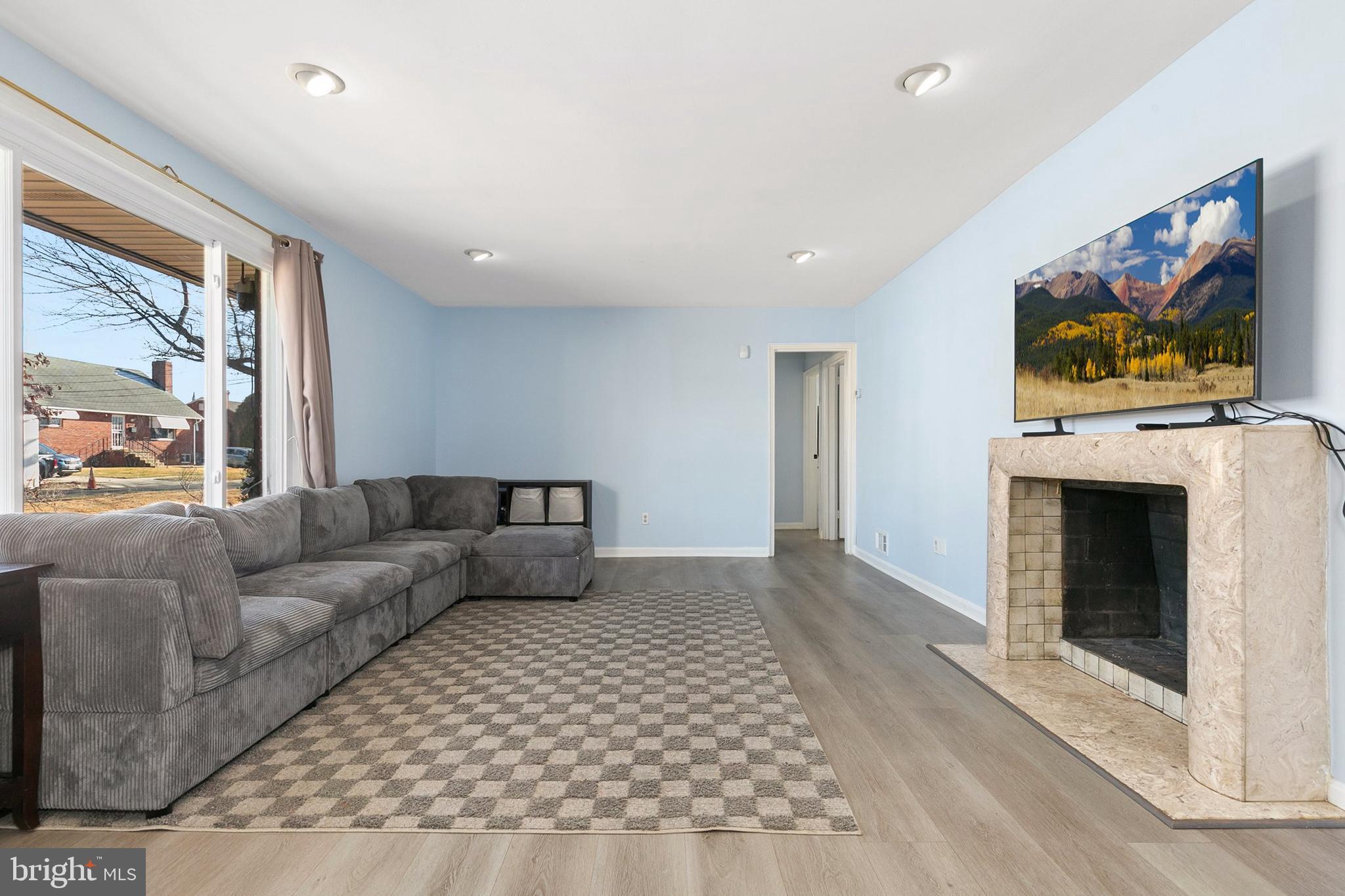 9632 Cottrell Terrace Silver Spring, MD 20903 - Photo 4 of 36 a living room with furniture a flat screen tv and a fireplace