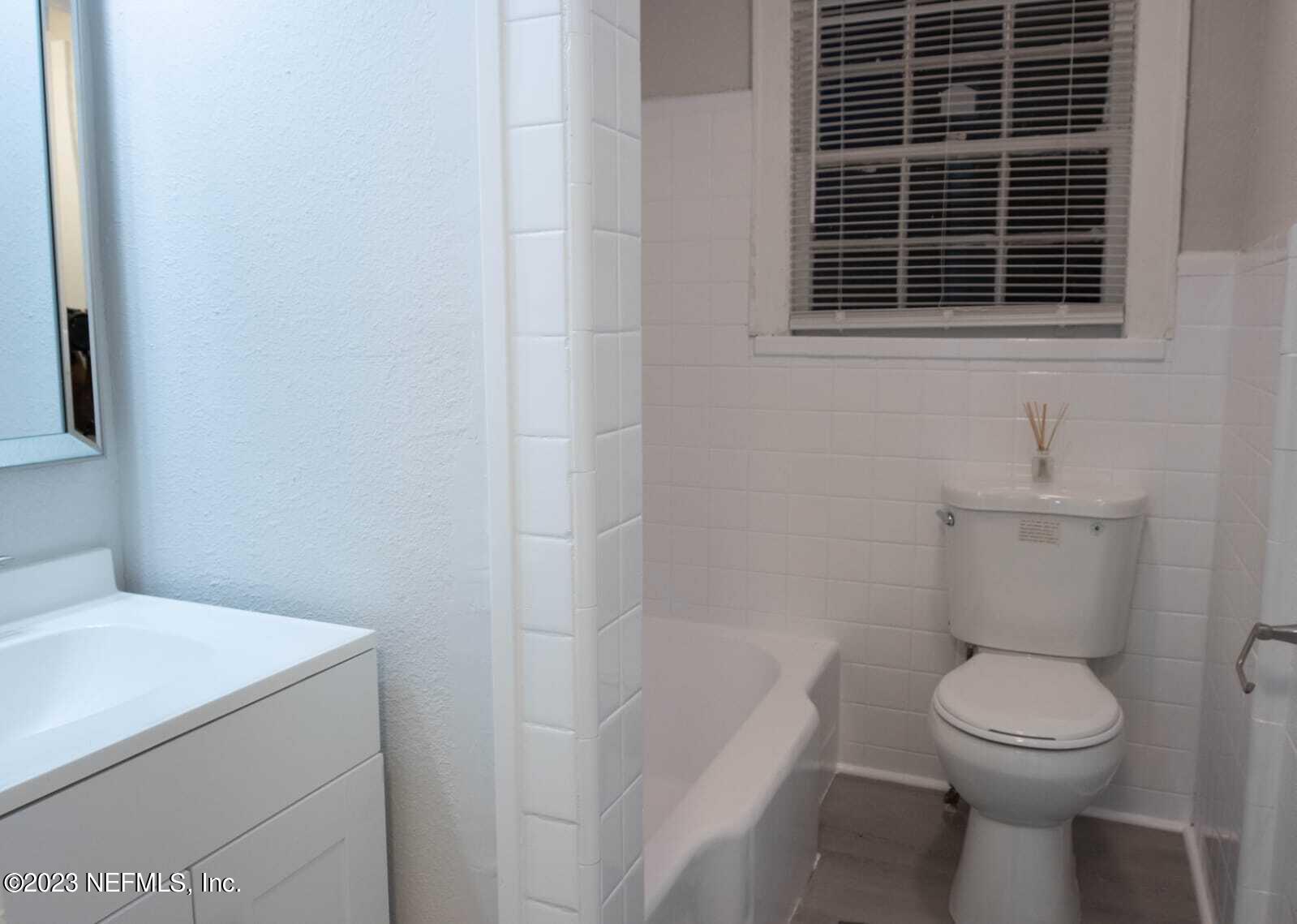 3910 Grant Road Jacksonville, FL 32207 - Photo 17 of 32 a white toilet sitting next to a bathroom sink