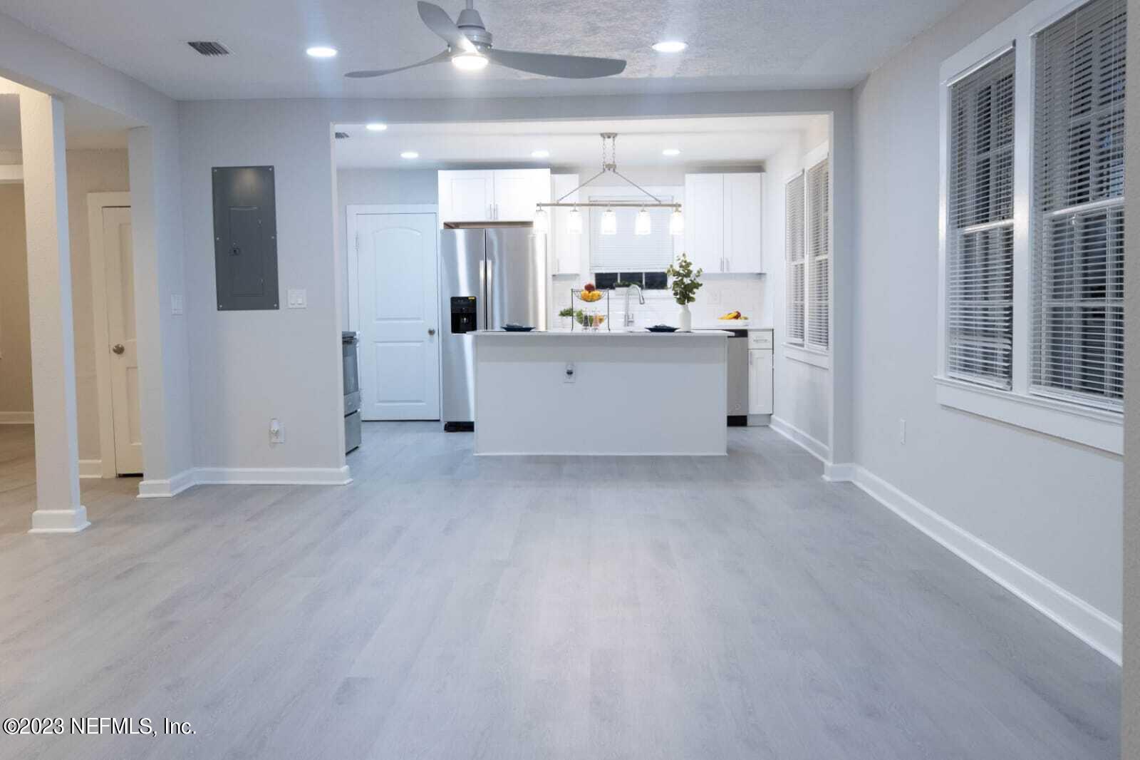 3910 Grant Road Jacksonville, FL 32207 - Photo 19 of 32 a view of an empty room with kitchen and window