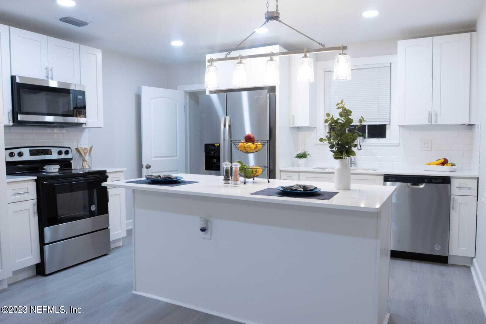 3910 Grant Road Jacksonville, FL 32207 - Photo 22 of 32 a kitchen with stainless steel appliances a sink stove and refrigerator