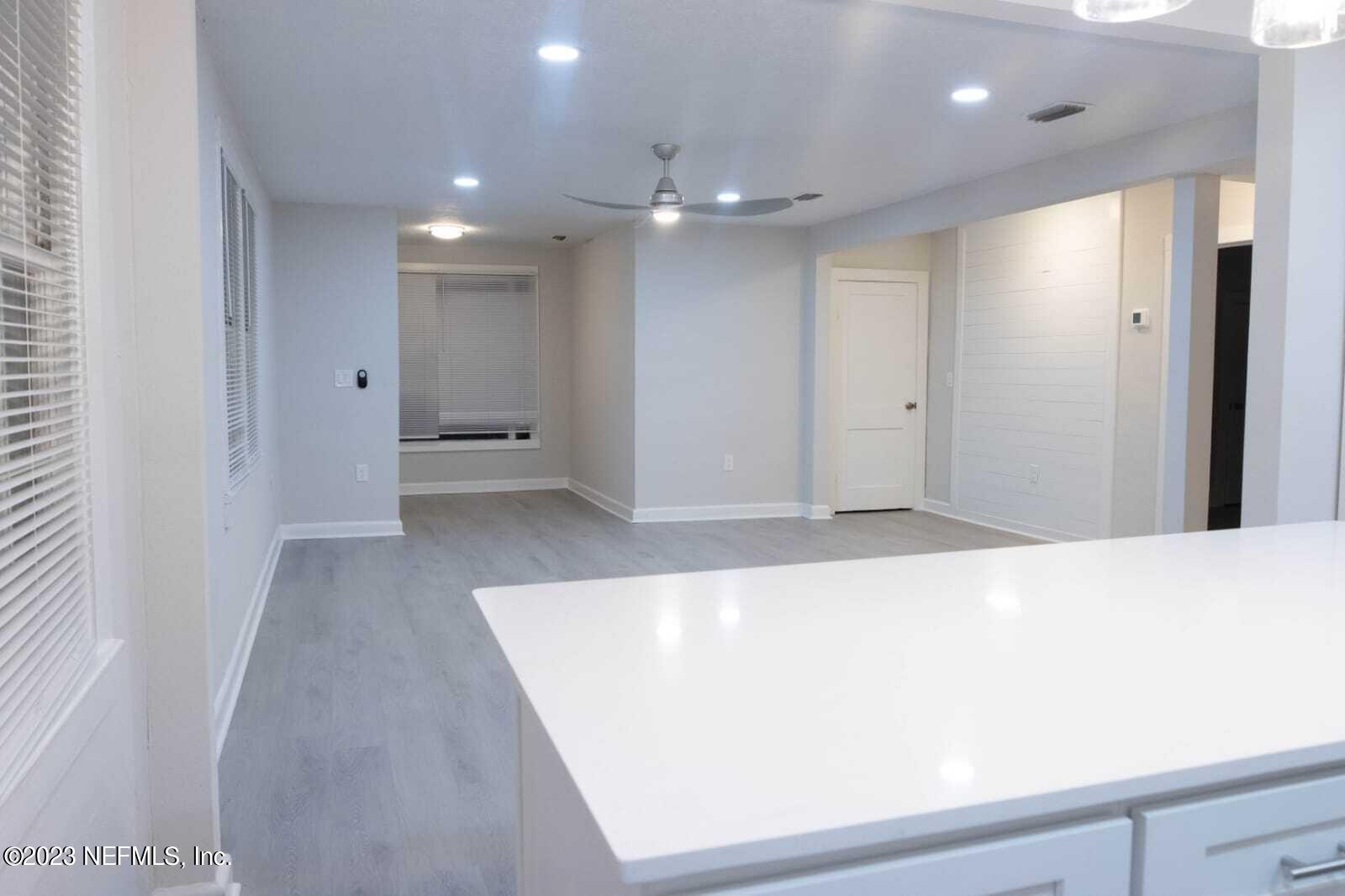 3910 Grant Road Jacksonville, FL 32207 - Photo 3 of 32 a view of a hallway with wooden floor