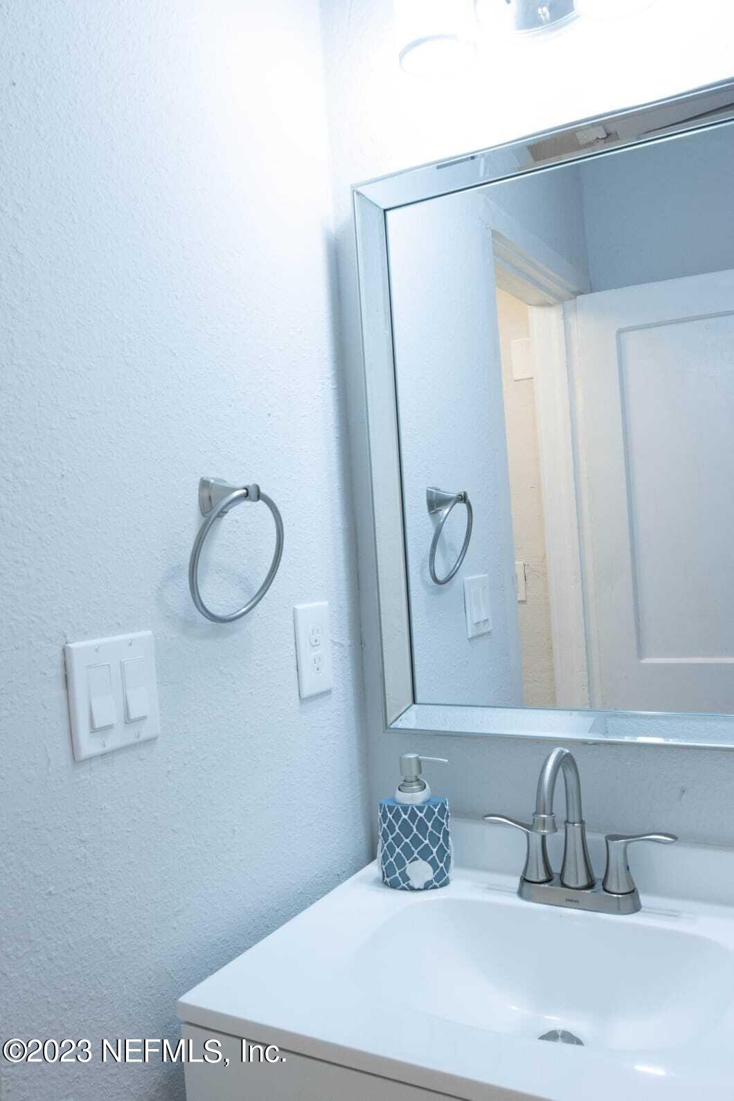 3910 Grant Road Jacksonville, FL 32207 - Photo 4 of 32 a bathroom with a sink and a mirror