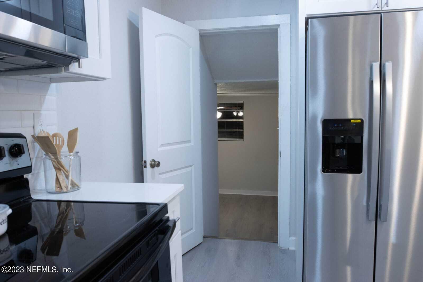 3910 Grant Road Jacksonville, FL 32207 - Photo 7 of 32 a kitchen with stainless steel appliances granite countertop a refrigerator and a stove