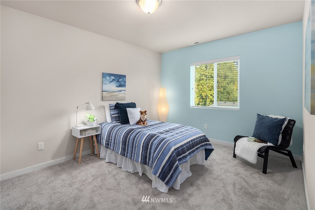 5 157th Lane Southeast Bothell, WA 98012 - Photo 16 of 27 a bedroom with a bed a chair and next to a window