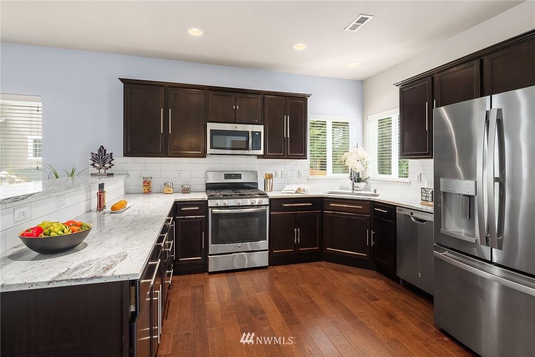 5 157th Lane Southeast Bothell, WA 98012 - Photo 5 of 27 a kitchen with stainless steel appliances a stove sink and refrigerator