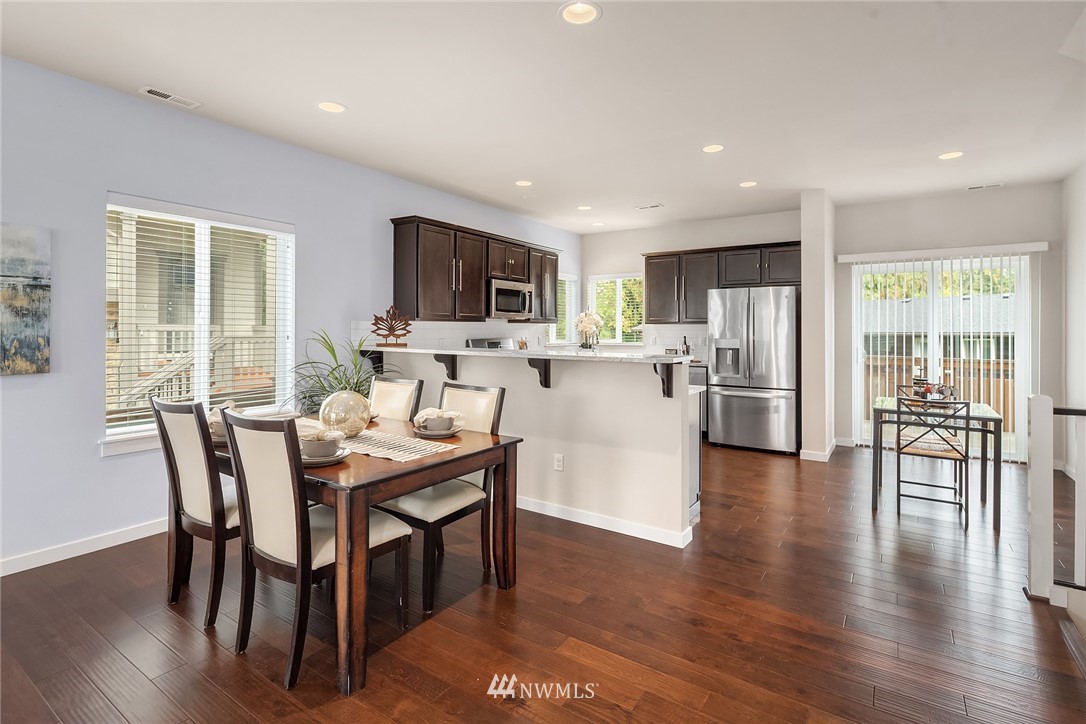 5 157th Lane Southeast Bothell, WA 98012 - Photo 8 of 27 a dining room with furniture a window and wooden floor