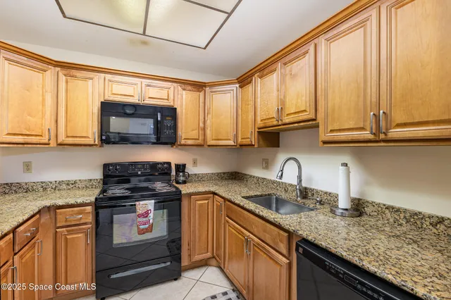 a kitchen with stainless steel appliances granite countertop a stove sink microwave and window