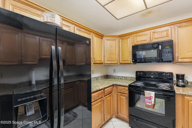 a kitchen with stainless steel appliances granite countertop a stove microwave and refrigerator