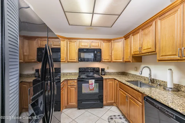 a kitchen with a sink a stove and cabinets