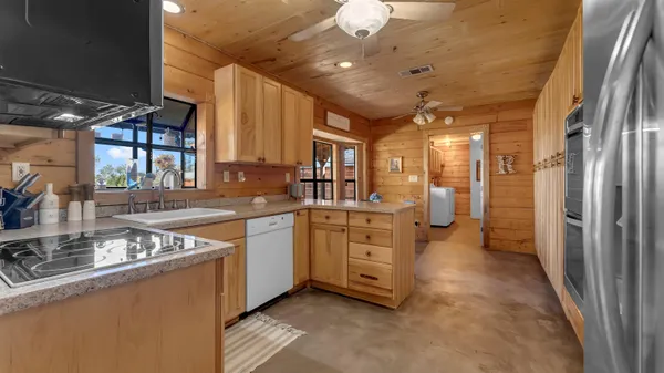 a kitchen with cabinets a sink and appliances