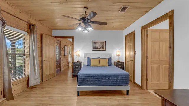 a bedroom with a bed and wooden floor
