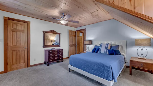 a bedroom with a bed and a chandelier