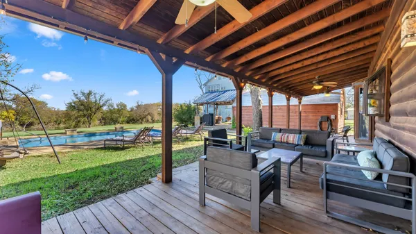 a living room with patio furniture and a wooden floor