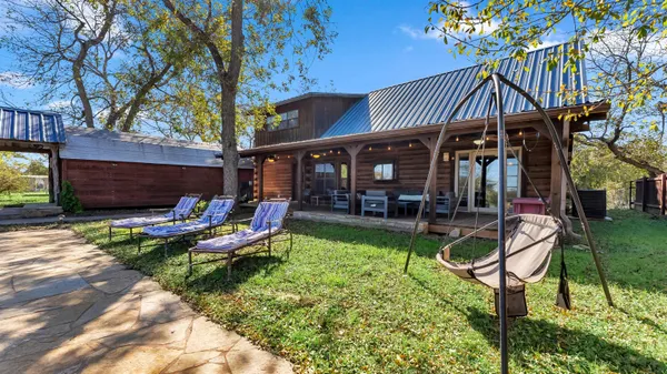 a view of a house with backyard porch and sitting area